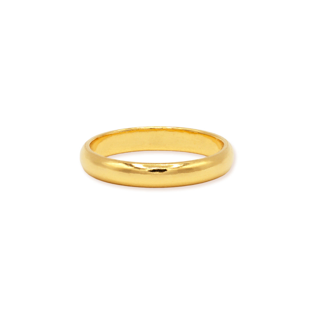 3mm 24k gold domed wedding band lying flat on white background