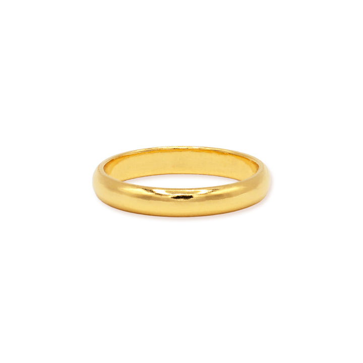 3mm 24k gold domed wedding band lying flat on white background
