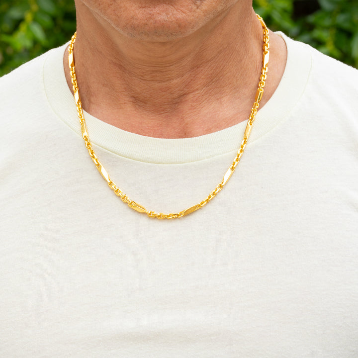 Man wearing 24k gold fancy link chain necklace, 4.5mm width, showing elegant drape