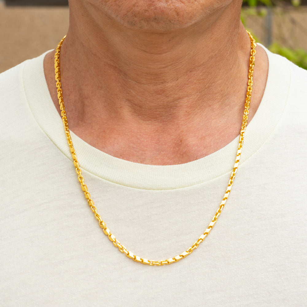 Man wearing 24k gold fancy link chain necklace, 4mm width, showing elegant drape