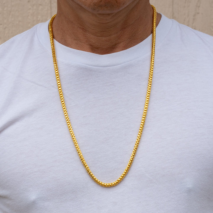 Model wearing 24k gold Franco chain necklace, 4.5mm width, 28 inch length
