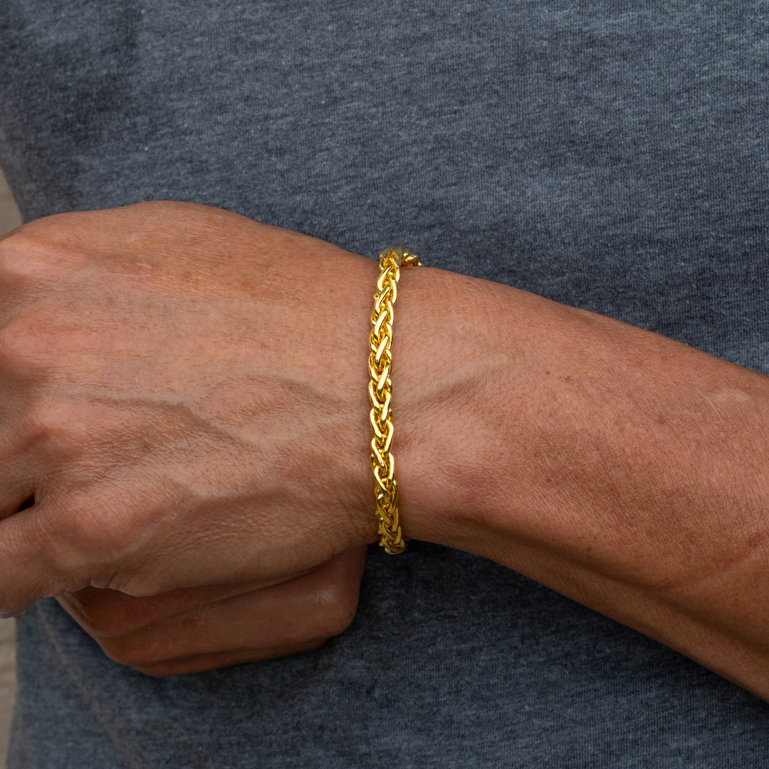 Man wearing 24k gold wheat bracelet on wrist