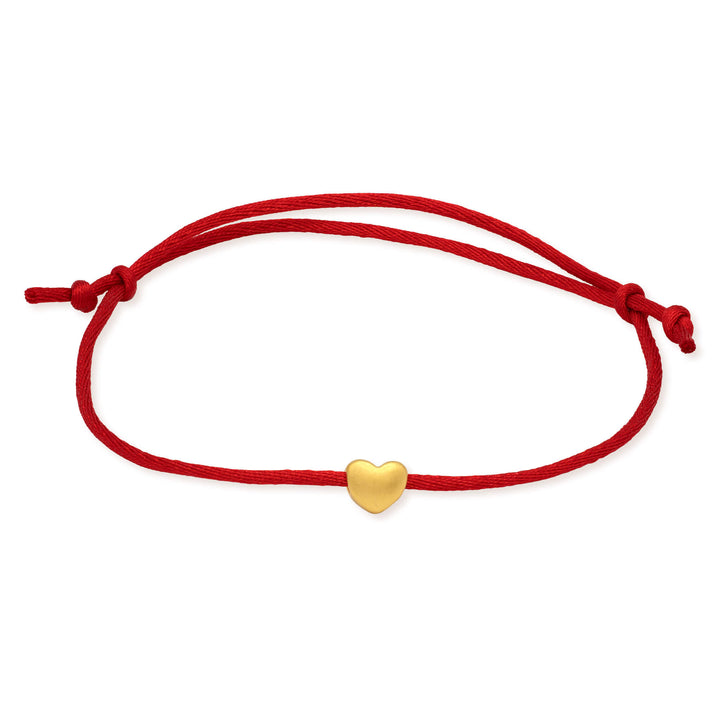 Red cord bracelet with a gold heart charm on a white background