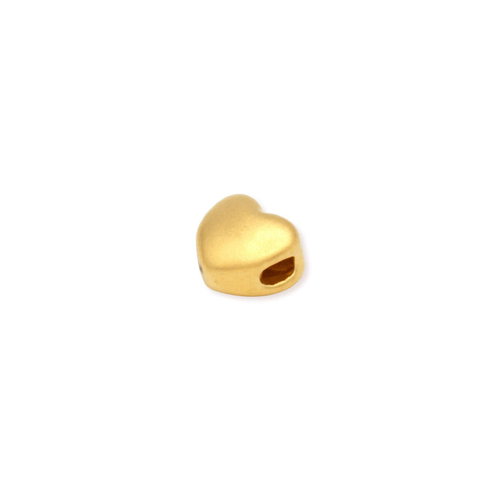 Side view of a 24k Gold heart-shaped charm on a white background